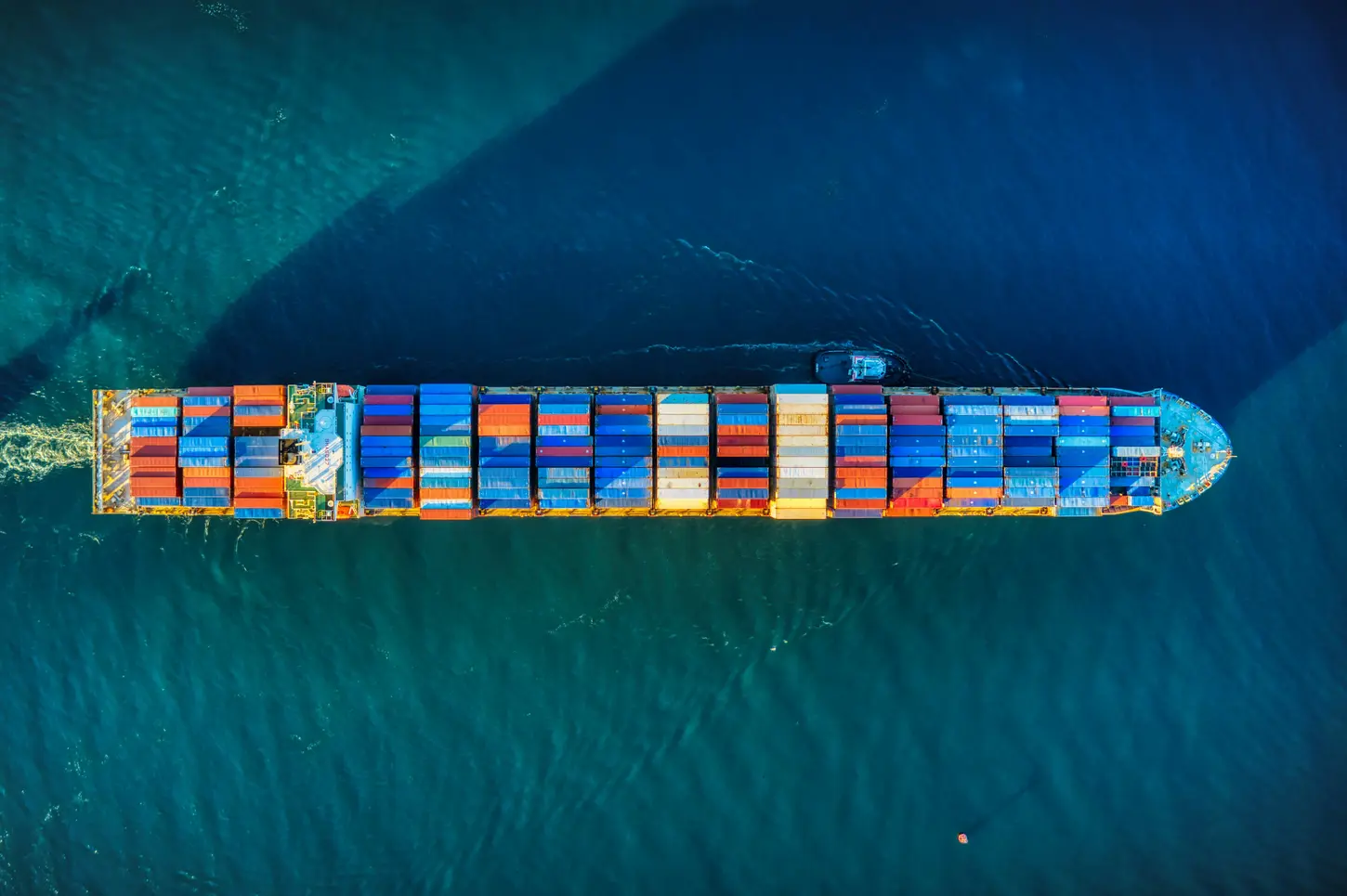 Container terminal with stacked containers and port cranes for sea freight from Surabaya